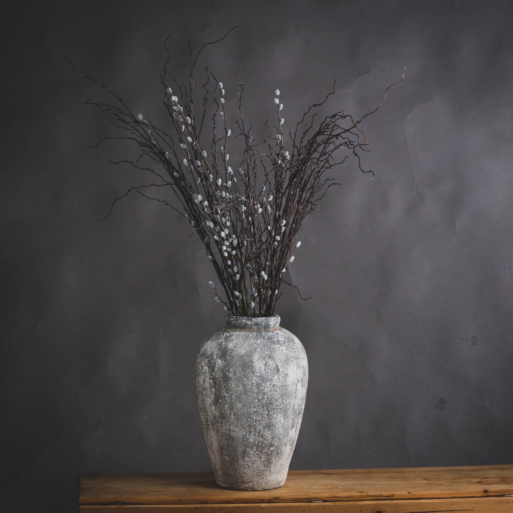 Rudlow Tall Textured Ceramic Vase styled beside a neutral wall with natural light revealing its aged surface and sculptural scale; styled as a standalone floor accent.