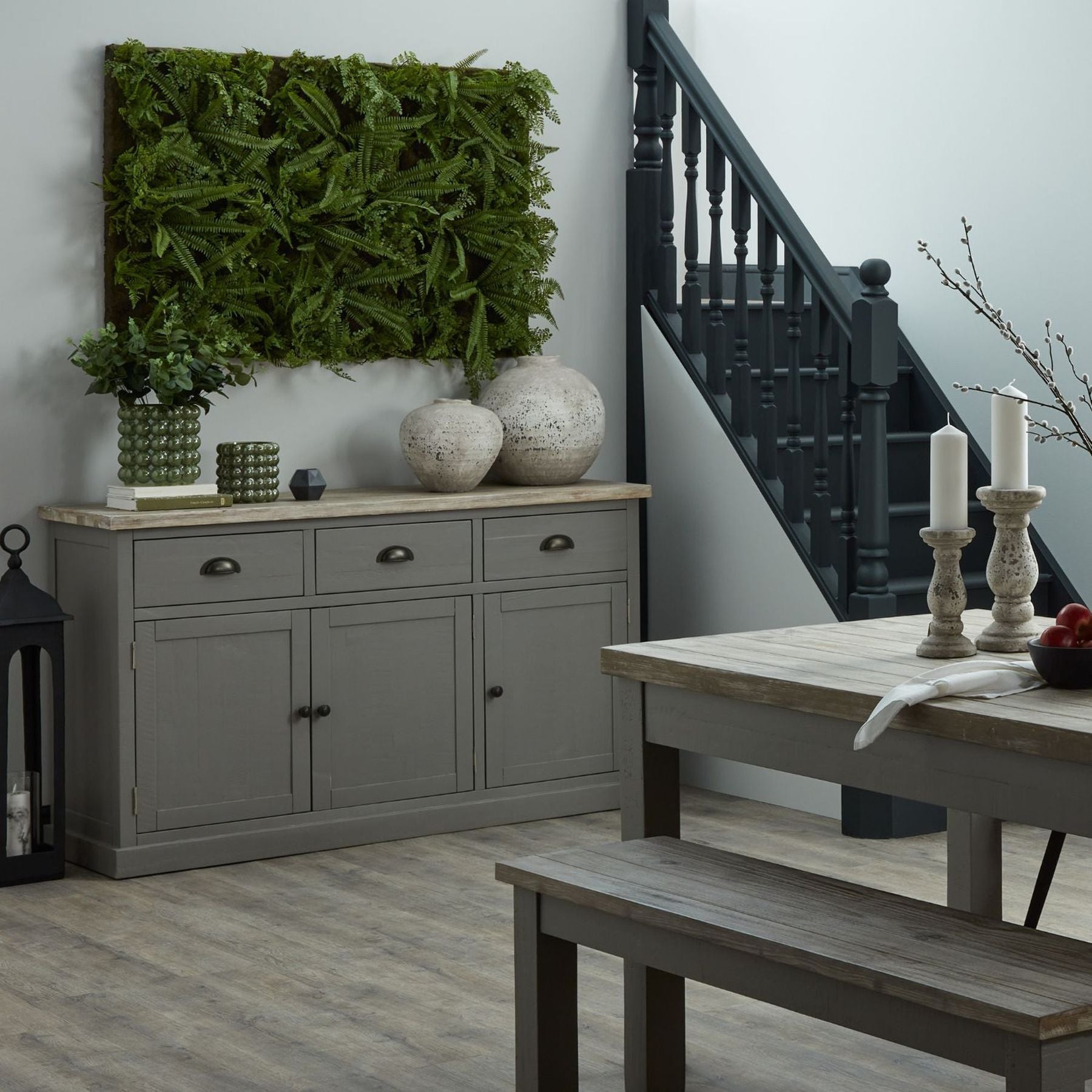 Harling Wide Round Ceramic Vase styled on a concrete plinth with natural light highlighting its cratered texture and minimalist, sculptural presence.