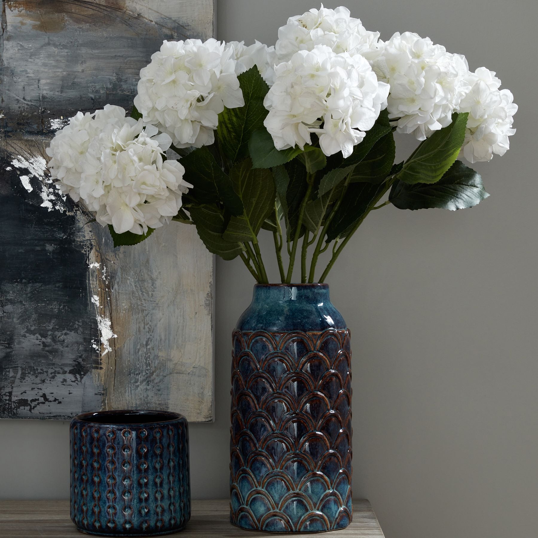 Tarnley Embossed Ceramic Planter styled on a neutral console surface, with natural light highlighting its verdigris glaze and raised vertical relief as a sculptural indoor accent.