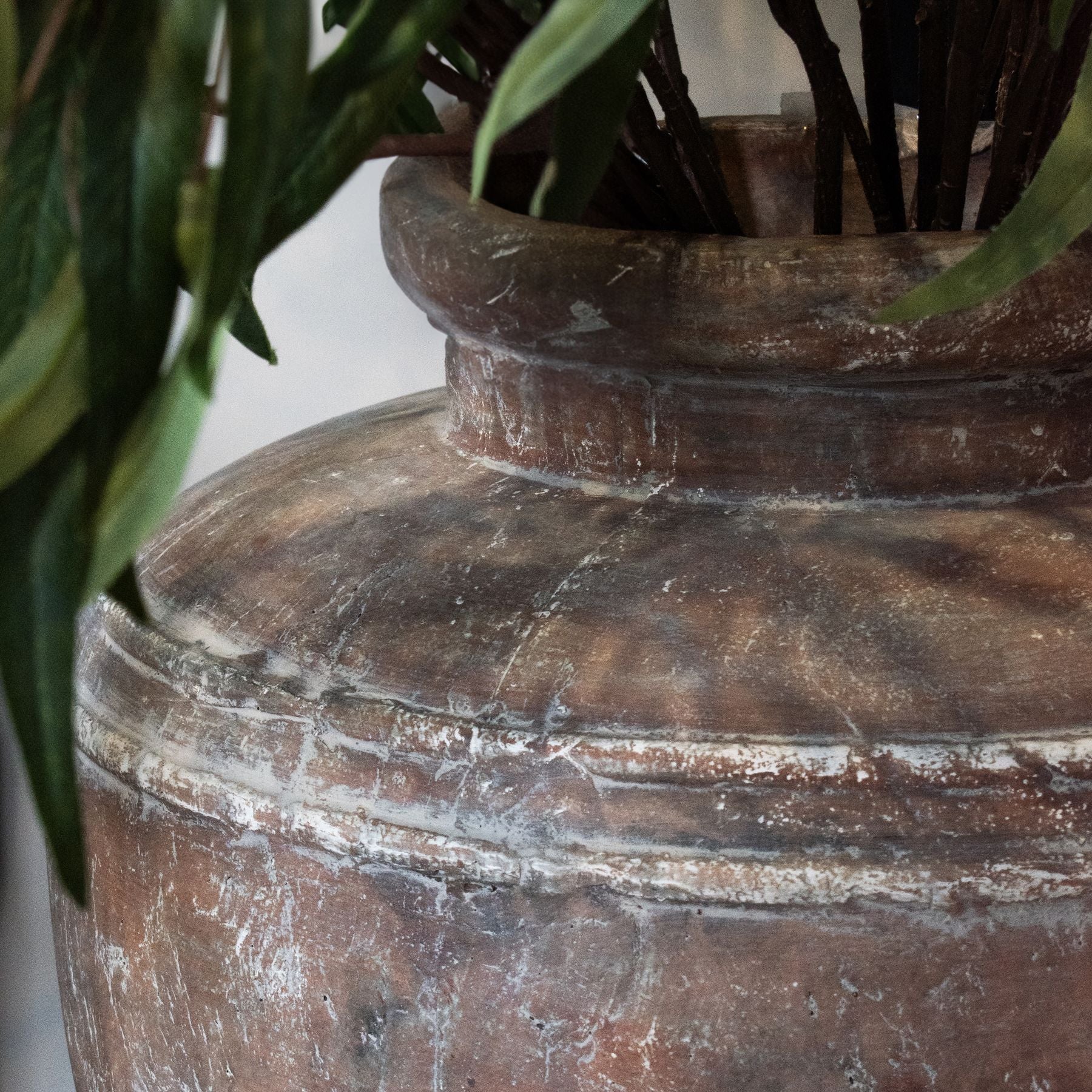 Lowther Stoneware Water Pot Planter styled in a neutral interior, placed near a corner with soft natural light highlighting its earthy matte glaze and sculptural vessel form.