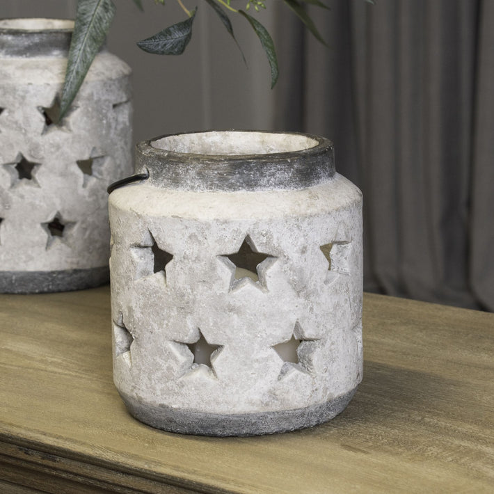 Lifestyle image of star lantern on wooden tabletop casting patterned ambient light