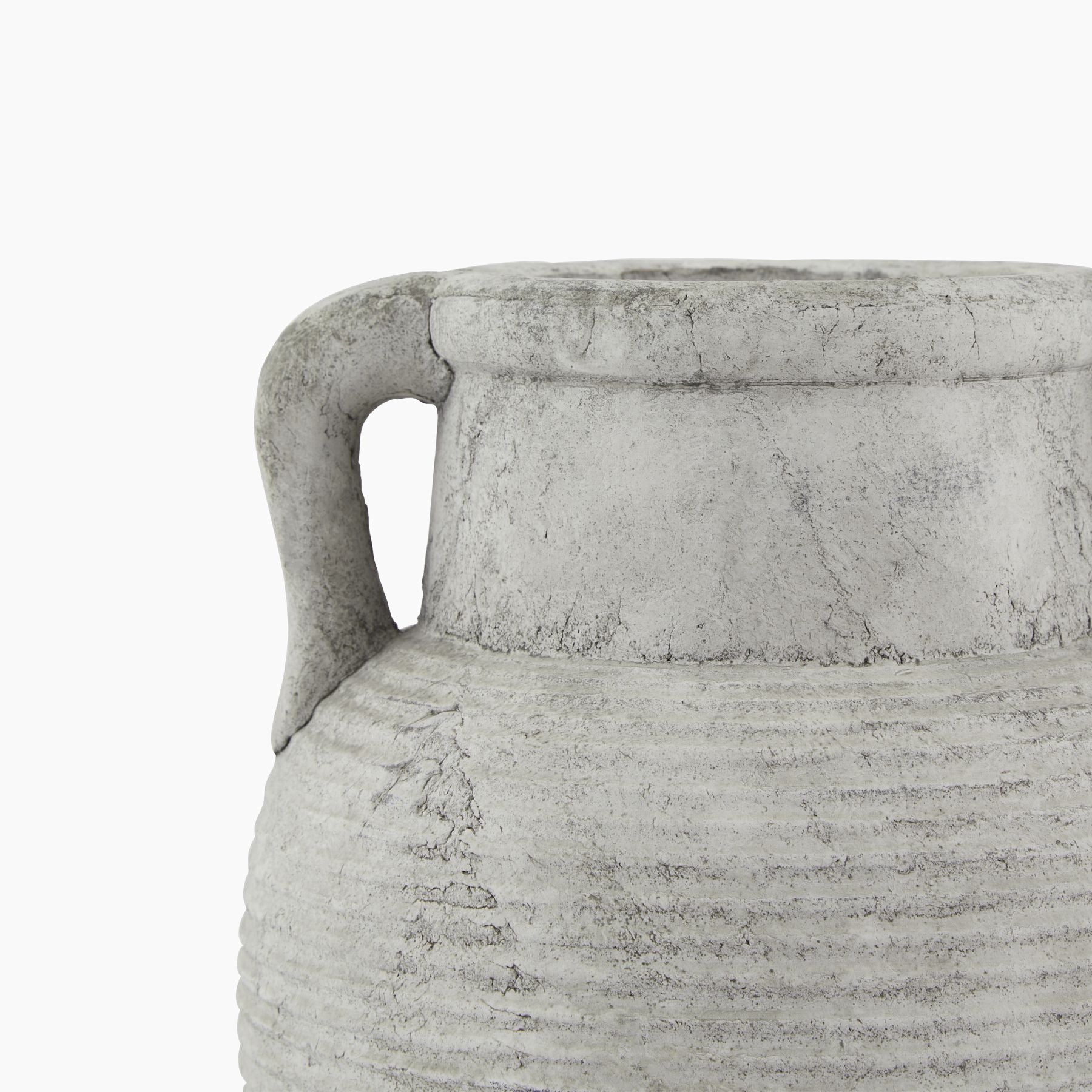 Close-up of matte stone-grey ribbed ceramic texture on Halden amphora vase.