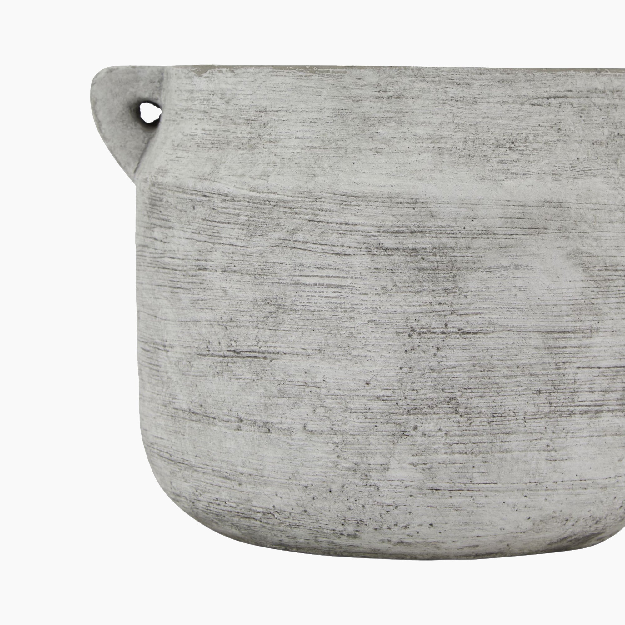 Side profile of the Halden Utility Stoneware Planter showing its grounded, barrel-like silhouette and raw textured finish in cool stone grey — a minimalist piece with subtle brutalist character.
