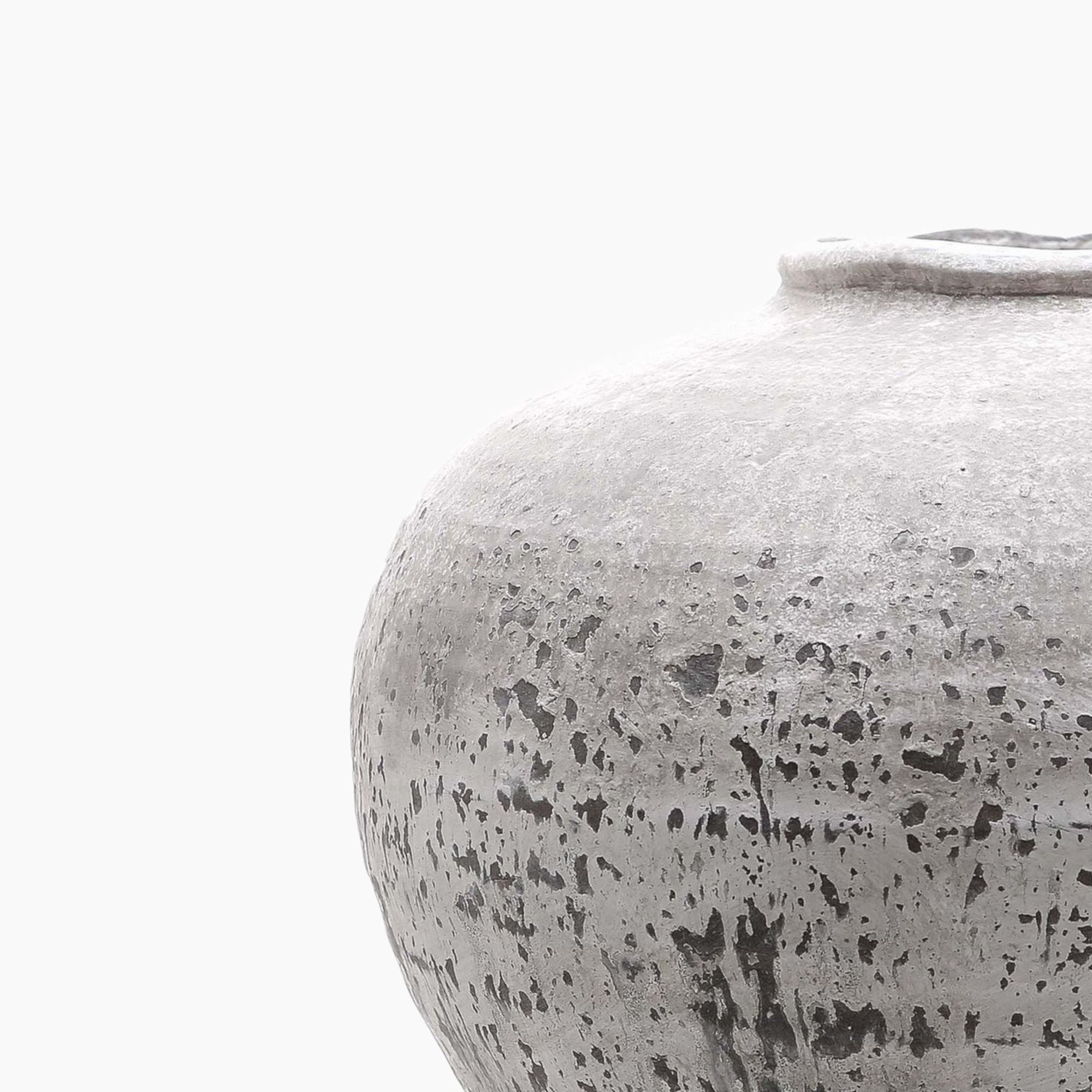 Side profile of the Harling Stone Ceramic Vase showing its low, rounded shape and textured stone-effect body with tonal grey variation.
