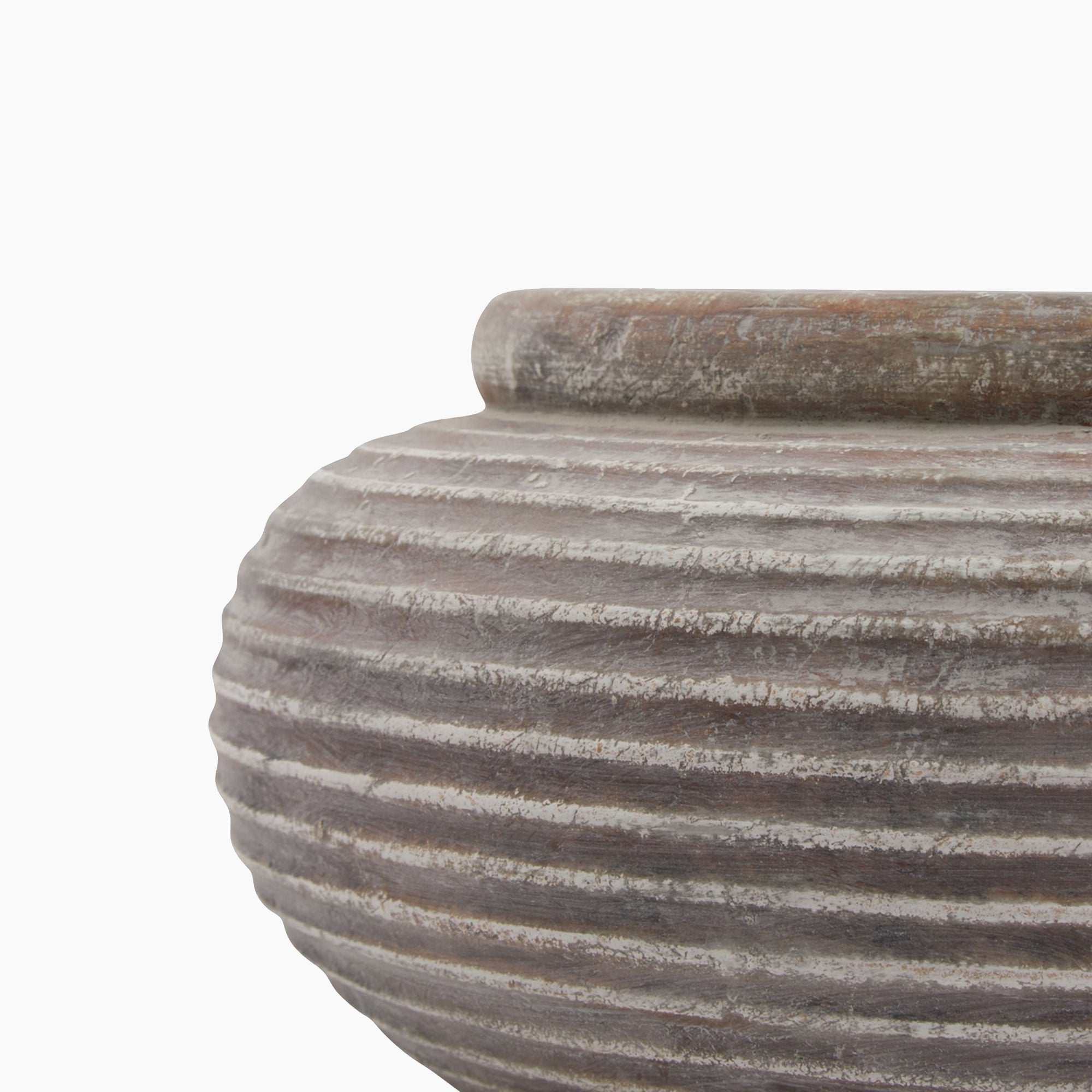 Side profile of the Lowther Ribbed Stoneware Bowl Planter highlighting its low, wide shape, ribbed surface, and sculptural form in a weathered clay finish.