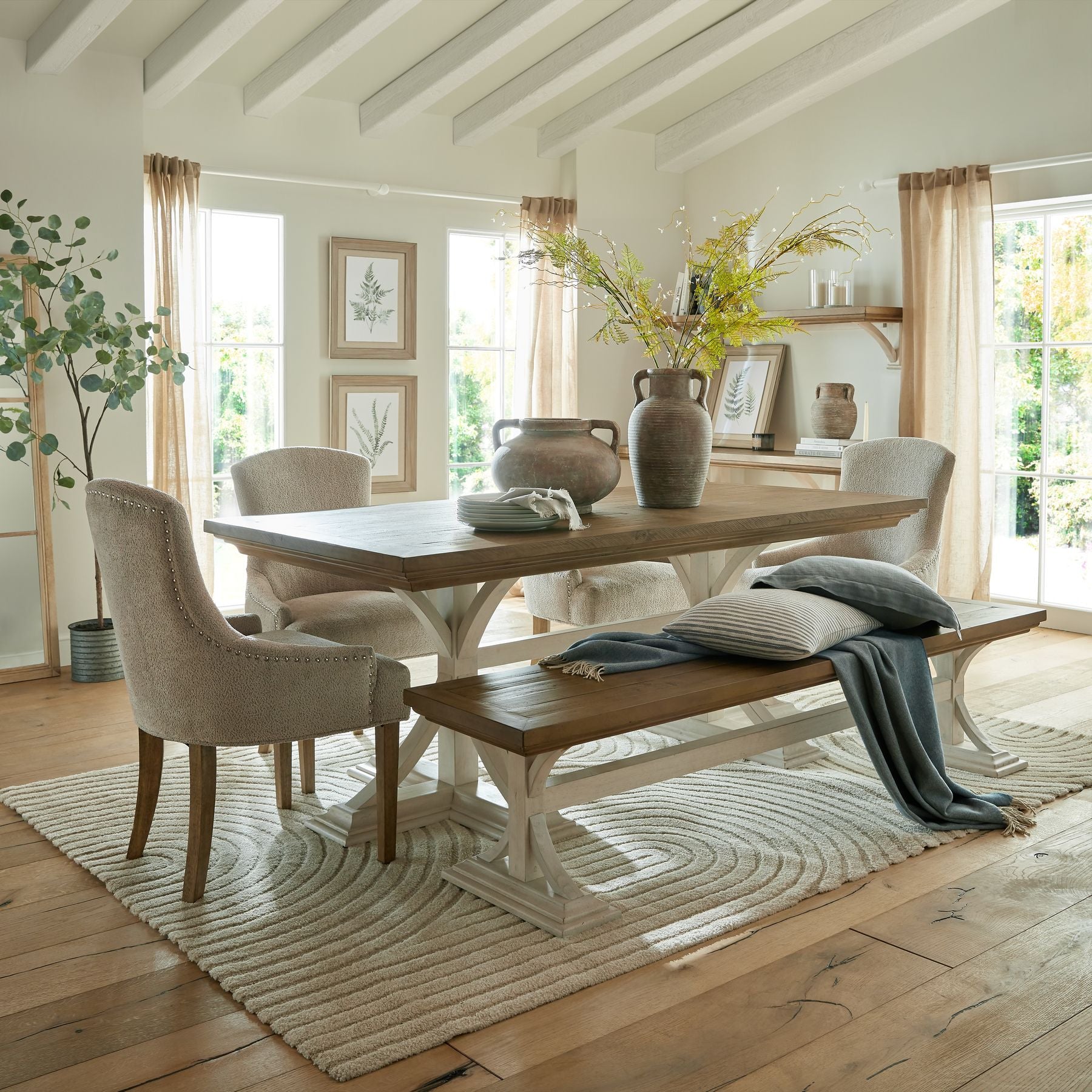Faux white willow branch styled in a neutral vase on wooden surface, ideal for spring or minimalist decor