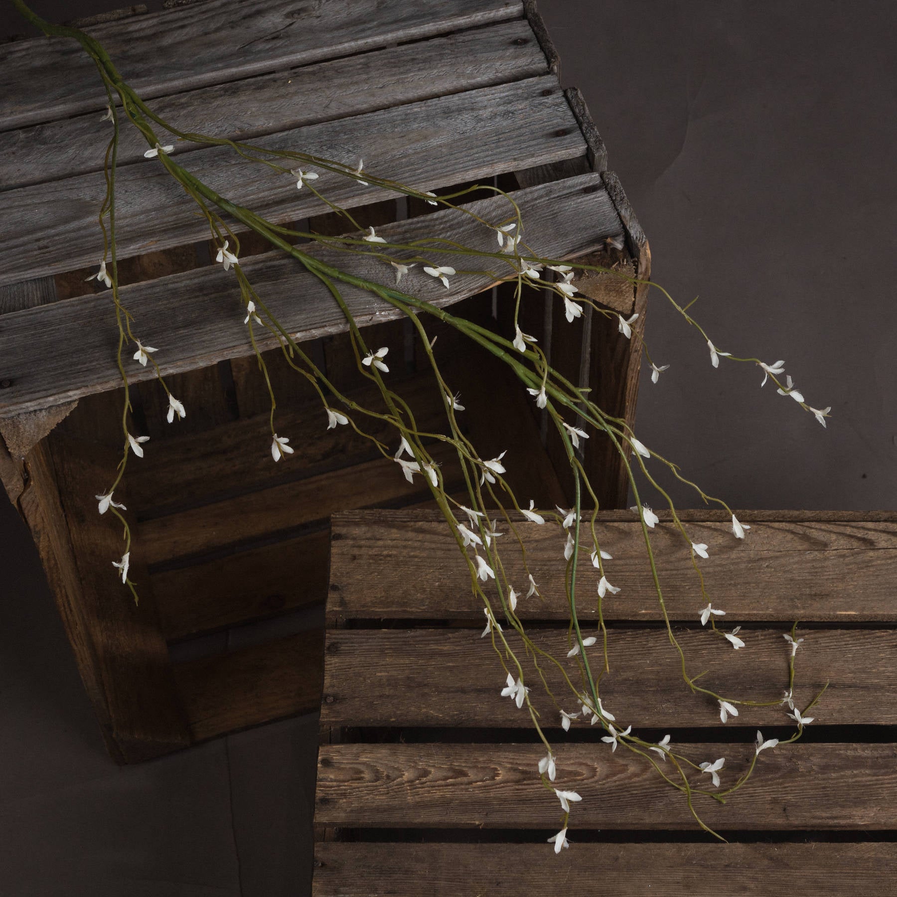 Detailed view of the White Willow Faux Spray showing realistic soft white buds, and green winding stem.