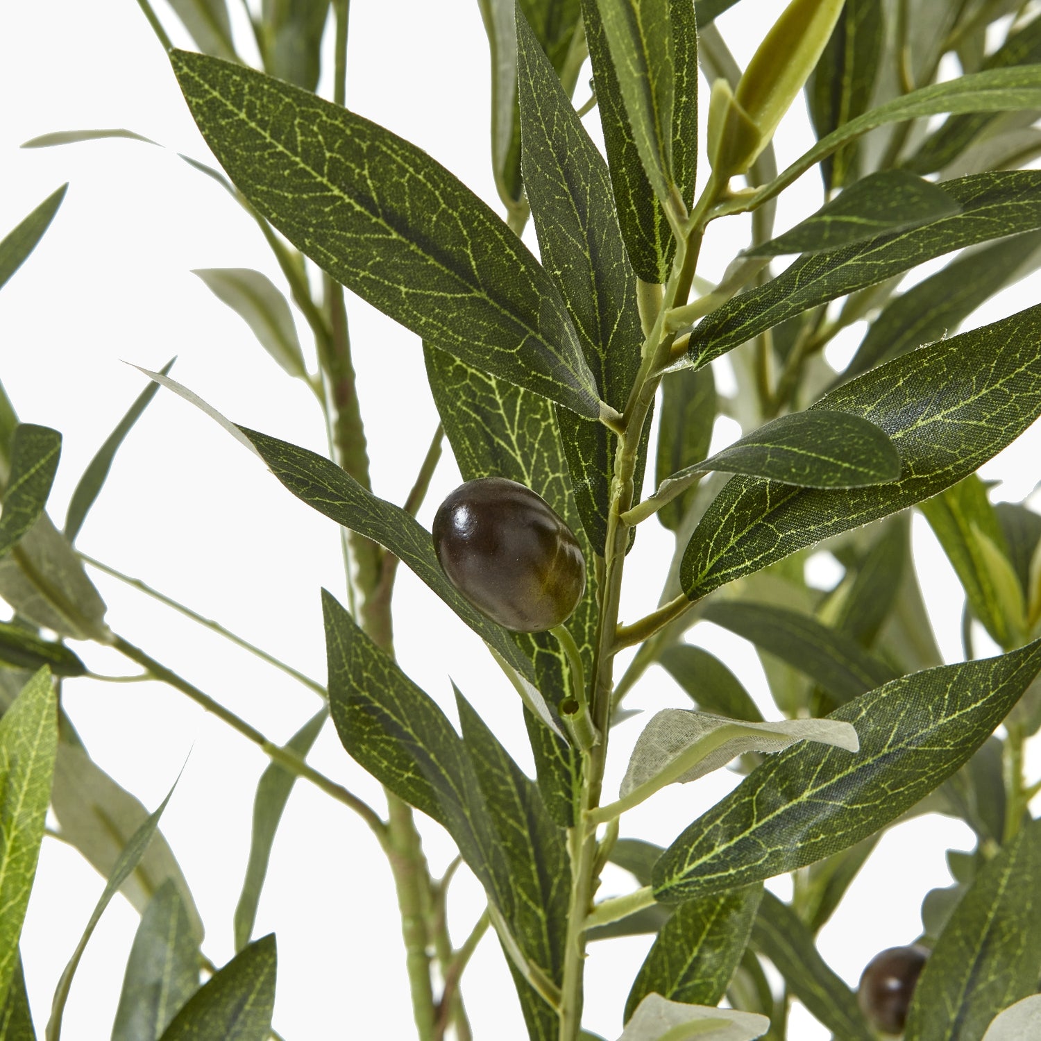 Angled view of artificial olive tree showing sculptural branch form and subtle veining on foliage