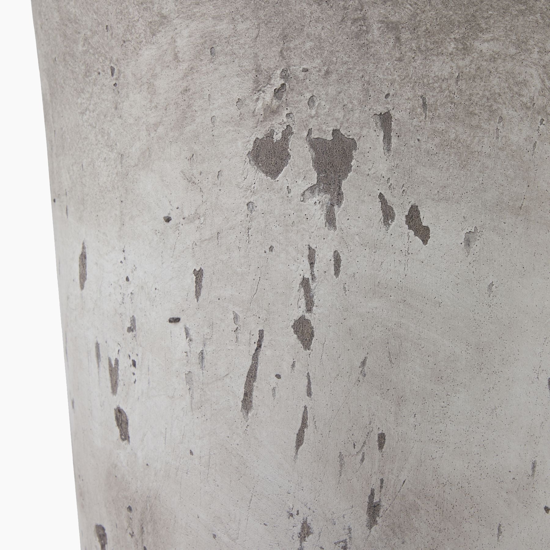 Side profile of the Winford Tall Stoneware Urn Planter, showcasing its elongated silhouette and tactile grey finish on a neutral studio background
