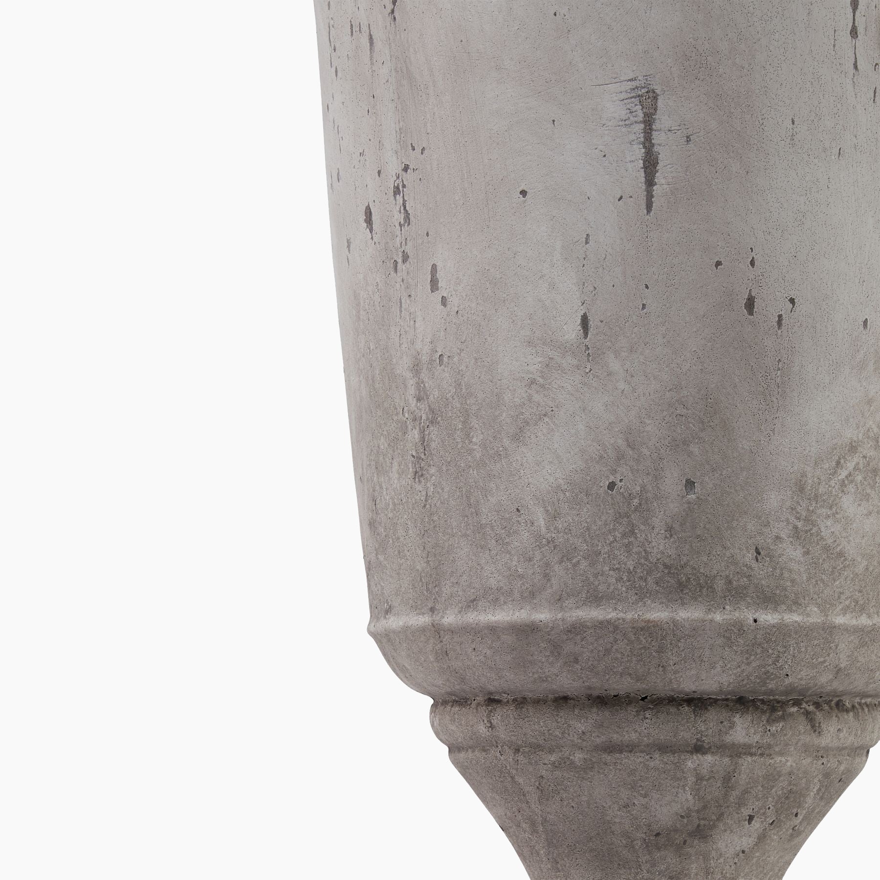 Side profile of the Winford Tall Stoneware Urn Planter, showcasing its elongated silhouette and tactile grey finish on a neutral studio background