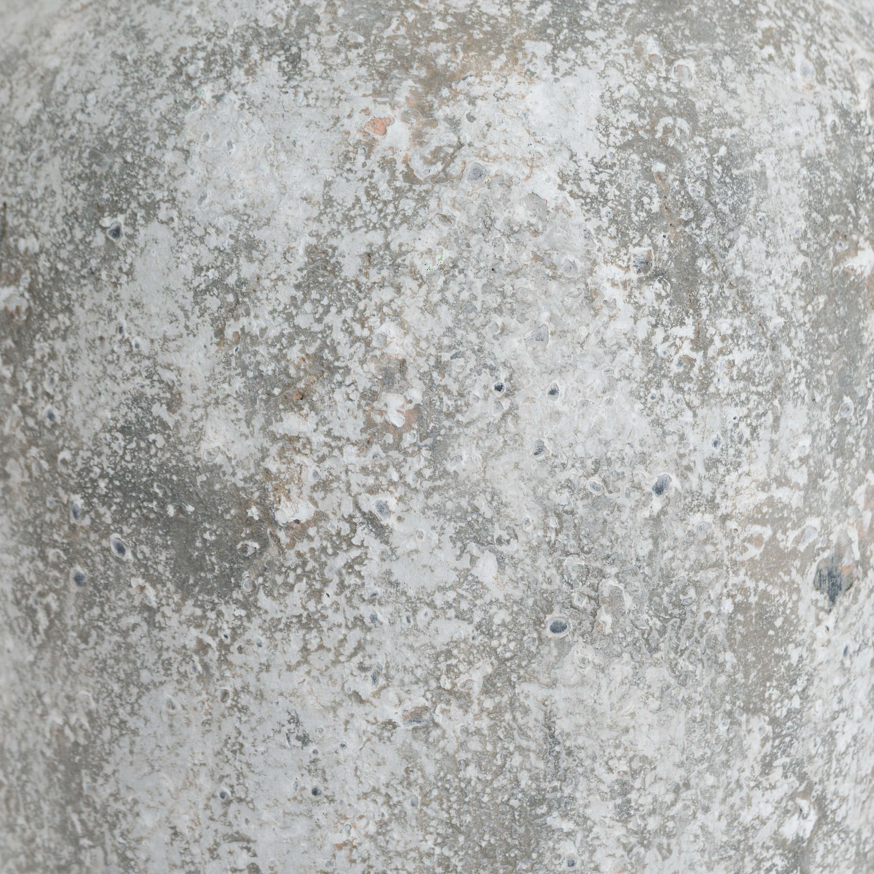 Side profile of the Rudlow Tall Textured Ceramic Vase highlighting its sculptural amphora form and irregular chalk-toned surface with layered texture.