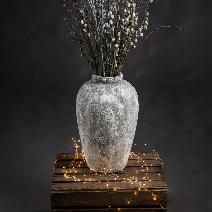 Rudlow Tall Textured Ceramic Vase styled beside a neutral wall with natural light revealing its aged surface and sculptural scale; styled as a standalone floor accent.