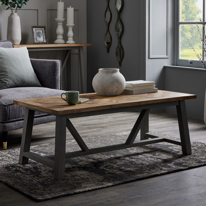 Lifestyle setting featuring the Bramley Stoneware Planter placed on a pale timber floor, its sculptural silhouette and raw stone texture contrasted against soft natural light, evoking a quiet, grounded presence within a minimal interior space.