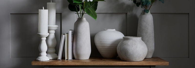 Lifestyle setting featuring the Bramley Stoneware Planter placed on a pale timber floor, its sculptural silhouette and raw stone texture contrasted against soft natural light, evoking a quiet, grounded presence within a minimal interior space.