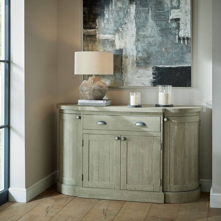 Lifestyle image of grey glass hurricane lantern on console table casting ambient glow in neutral interior