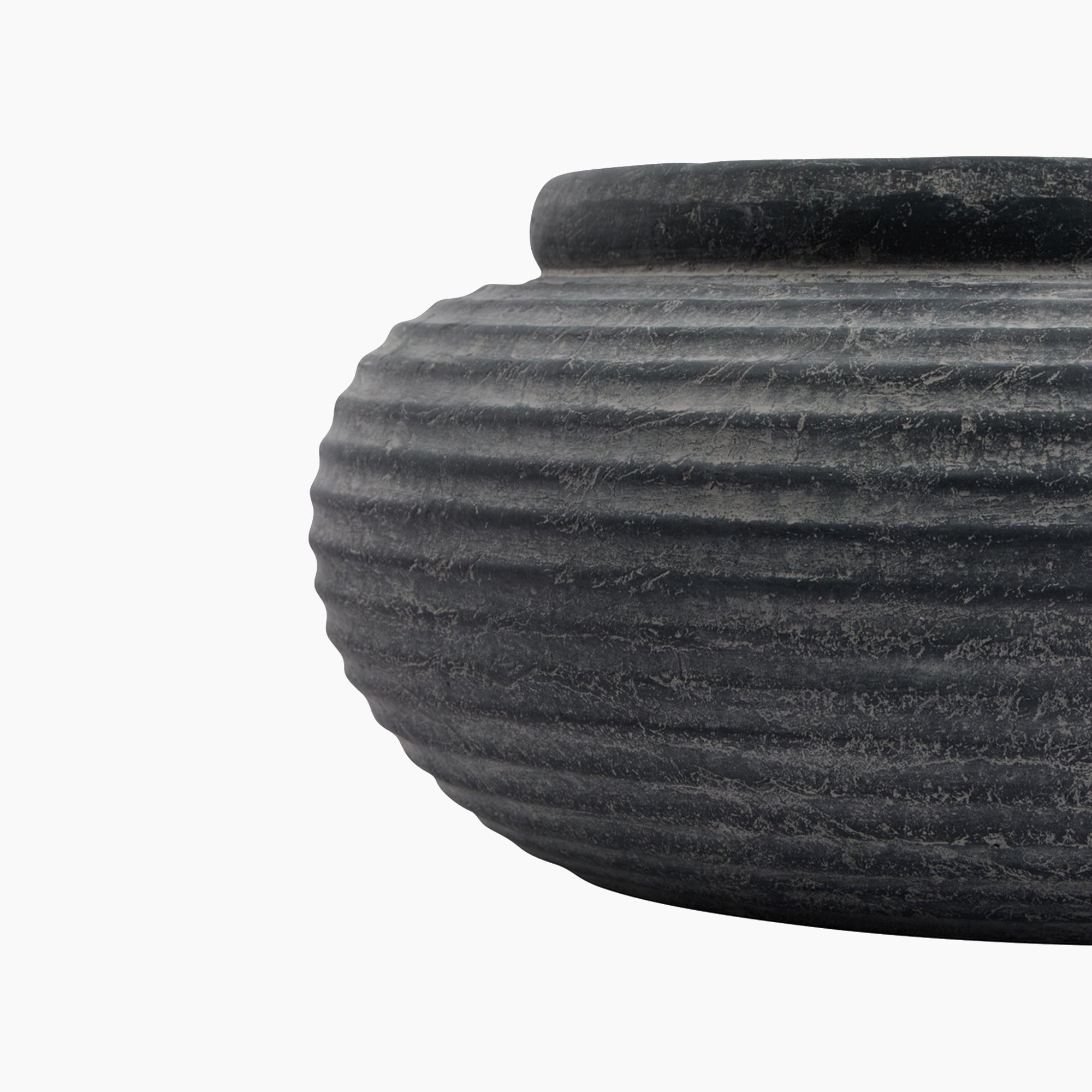 Side profile of the Ashbury Ribbed Stoneware Bowl Planter in slate black, highlighting its curved form, low height, and deep ribbed texture around the exterior.