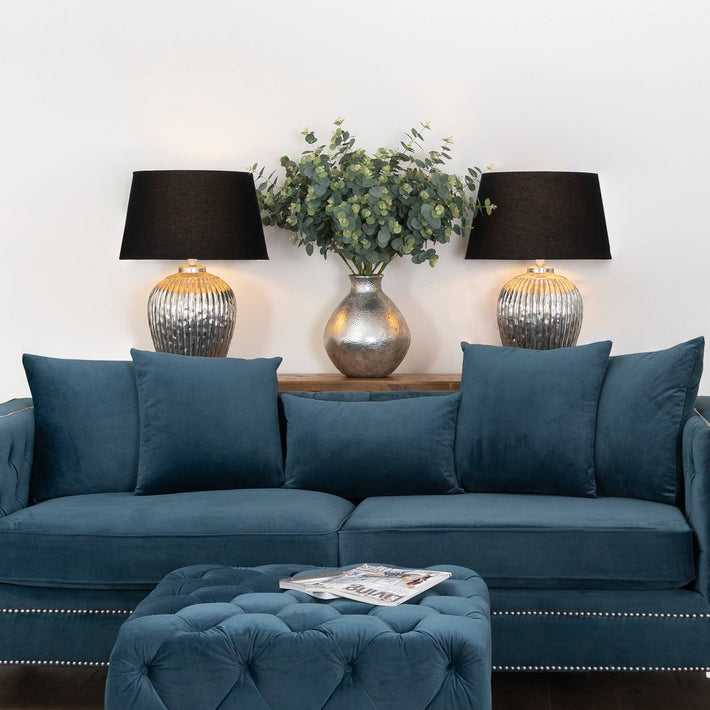 Lifestyle shot of faux eucalyptus bunch styled in a minimalist, brutalist interior setting