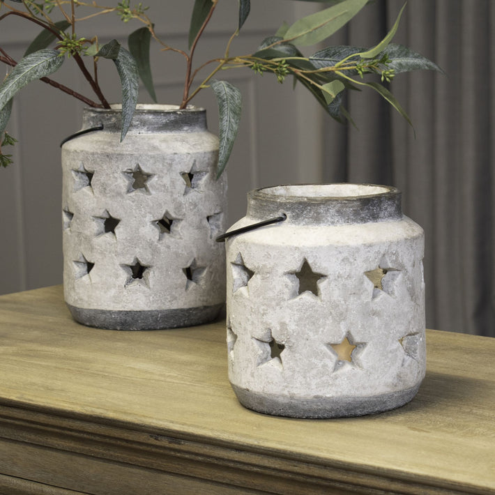 Lifestyle image of star lantern on wooden tabletop casting patterned ambient light