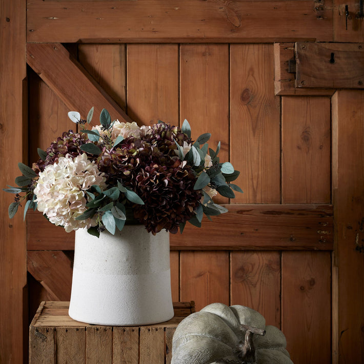 Artificial white hydrangea stems arranged in Christies Interior Harling Wide Vase
