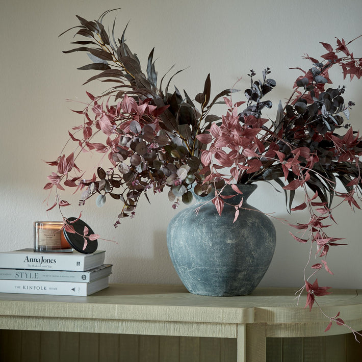 Burgundy eucalyptus faux bunch styled in ceramic vase, perfect as an artificial floral arrangement for living rooms, dining tables, or hallway decor.