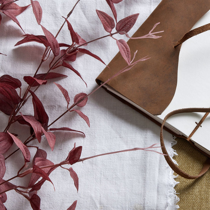 Angled view of burgundy leaf faux branch, deep wine-red foliage crafted from resin and fabric for sculptural room styling