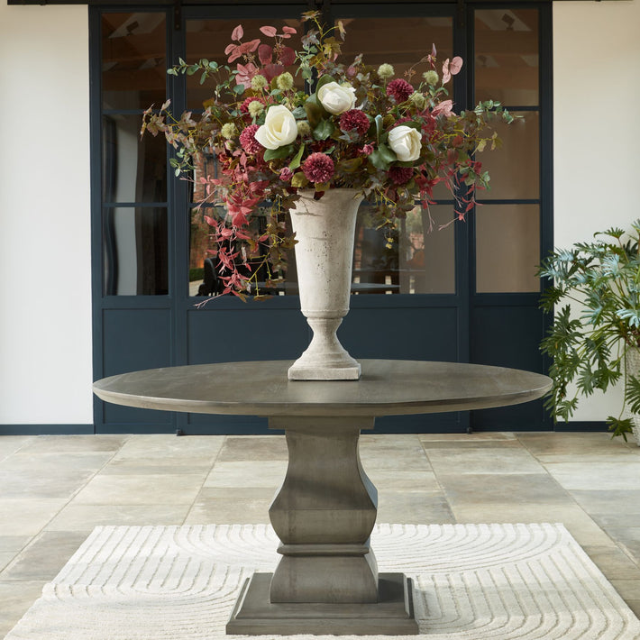 Burgundy leaf faux branch styled in tall stoneware vase, artificial foliage accent for Scandinavian and brutalist interiors
