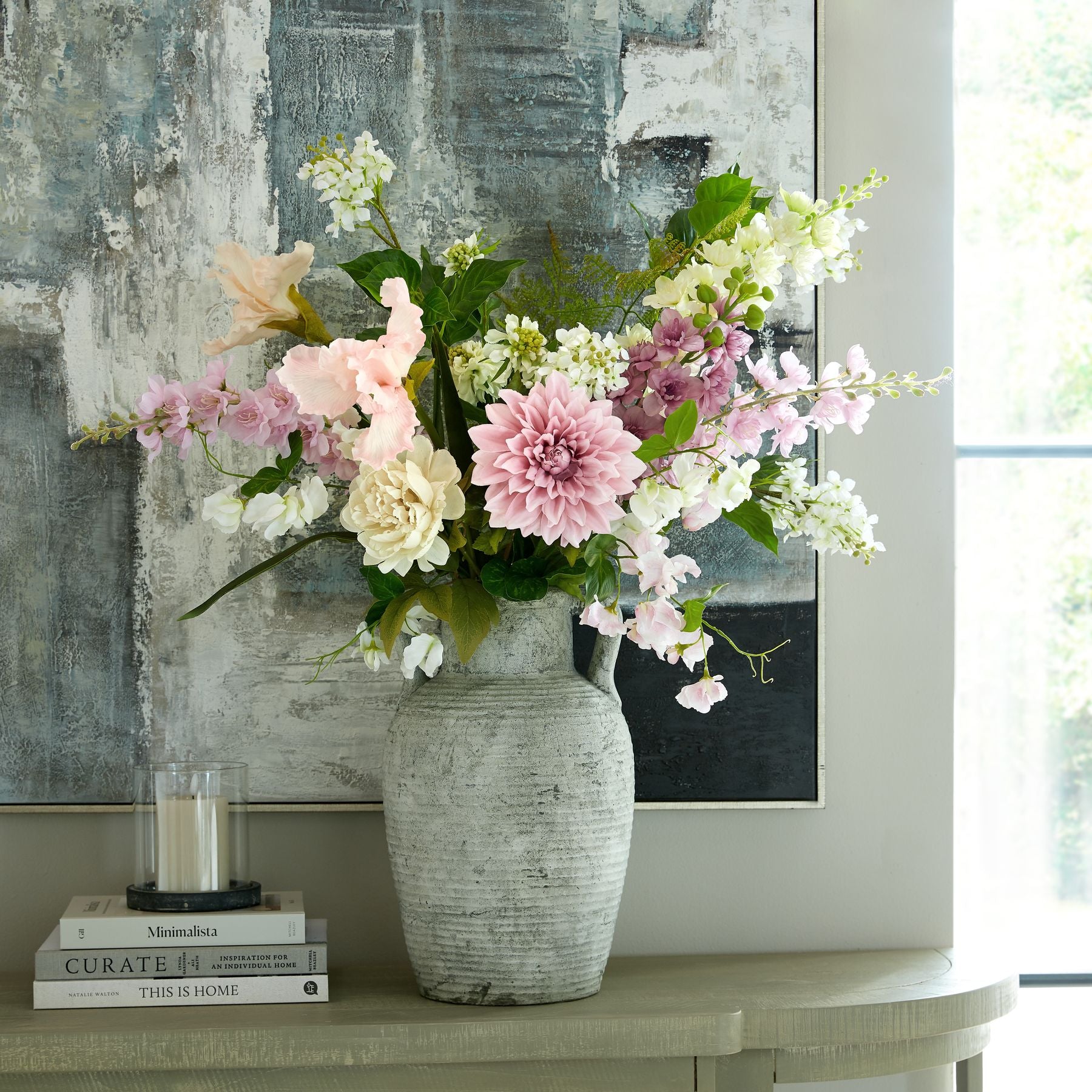 Halden stoneware amphora vase styled with tall faux flowers on console table
