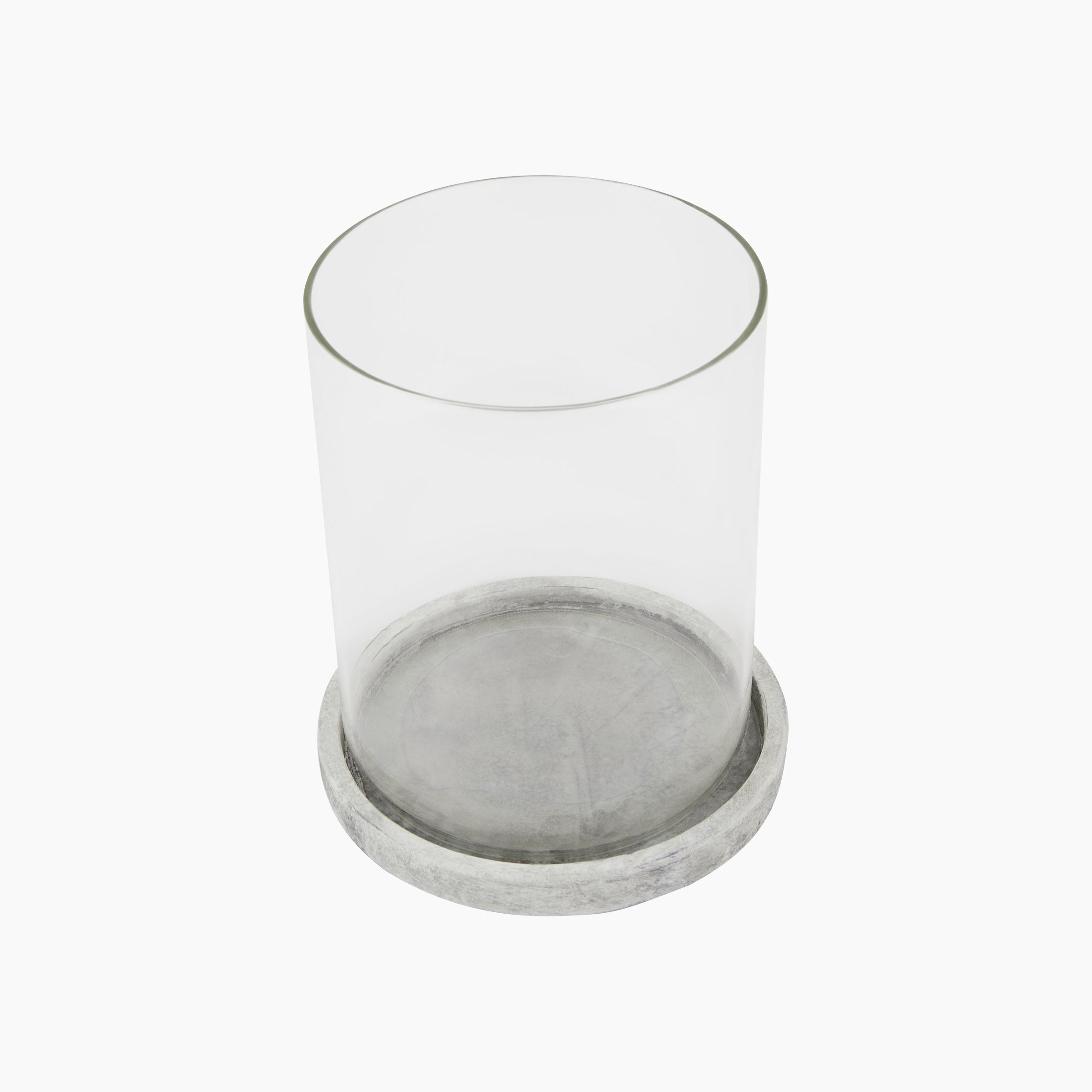 Top angled view of the Halden Large Hurricane Lantern, highlighting stone-grey cement base and clear curved glass for contemporary candle styling
