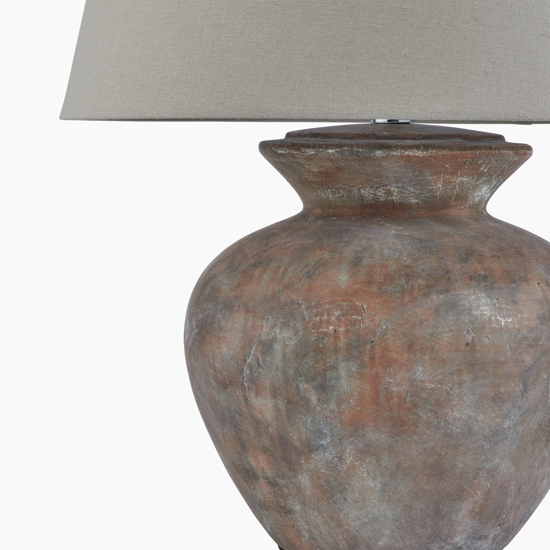 Side angle showing rounded brown ceramic base and neutral linen shade profile