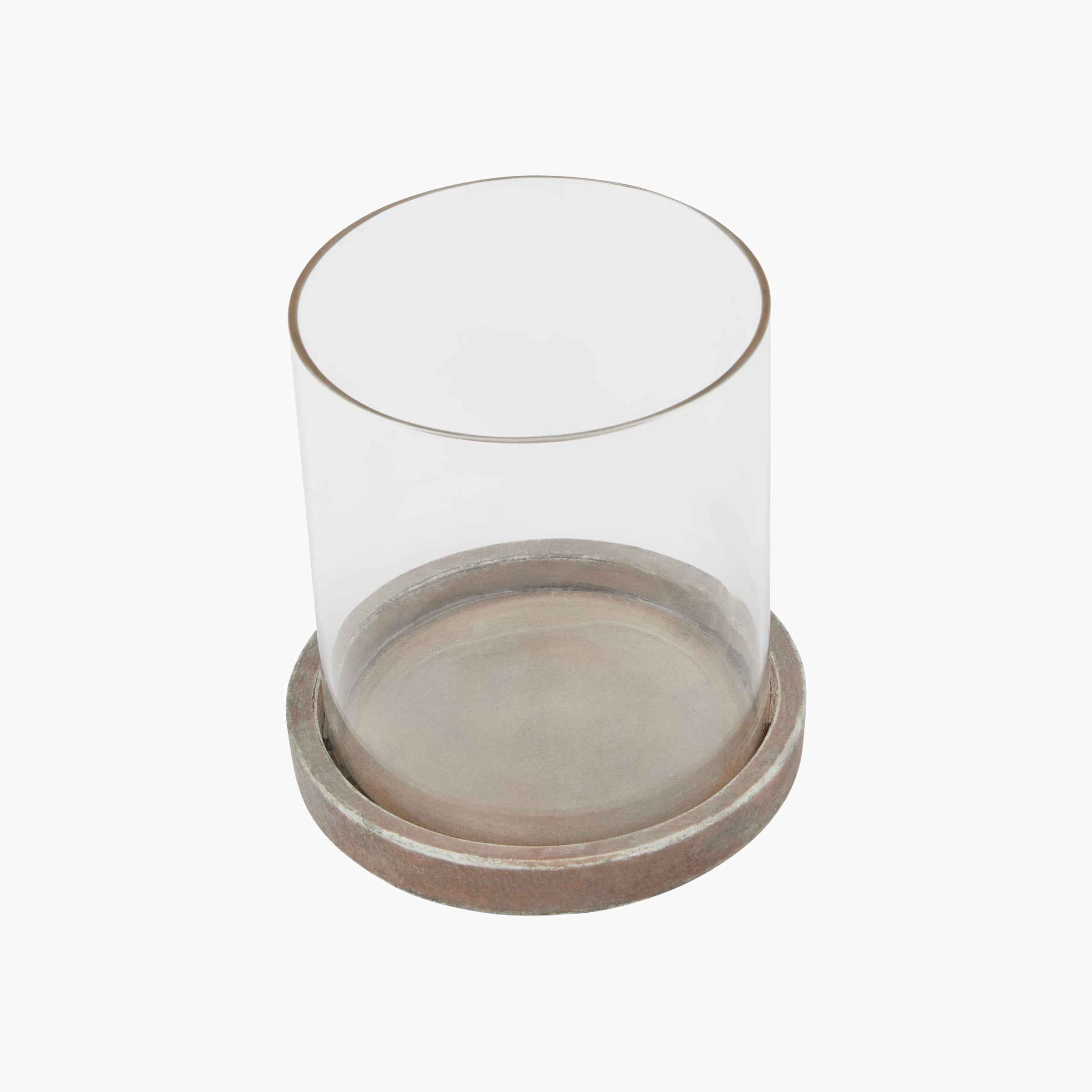 Angled view highlighting the sculptural form of the Lowther Hurricane Lantern in clay brown with clear glass.