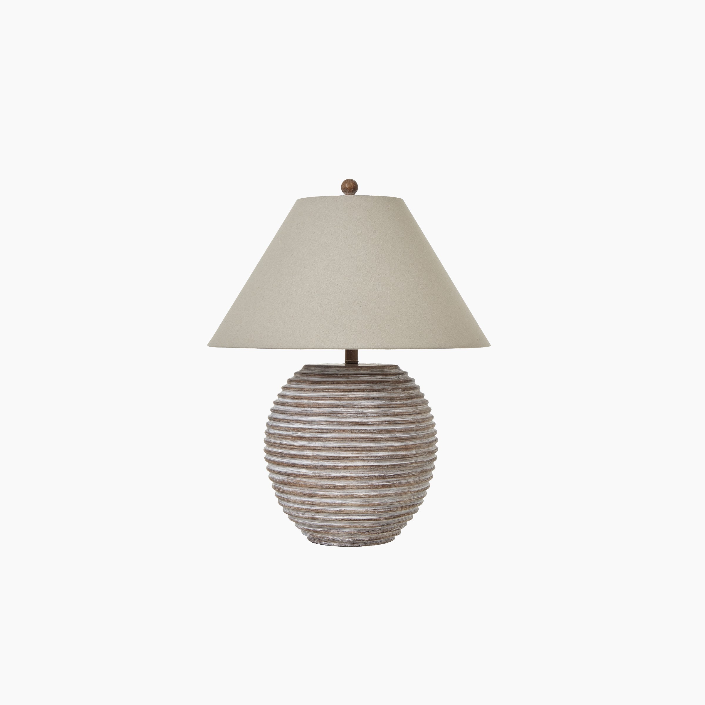 Front view of ribbed stone ceramic table lamp with neutral linen shade