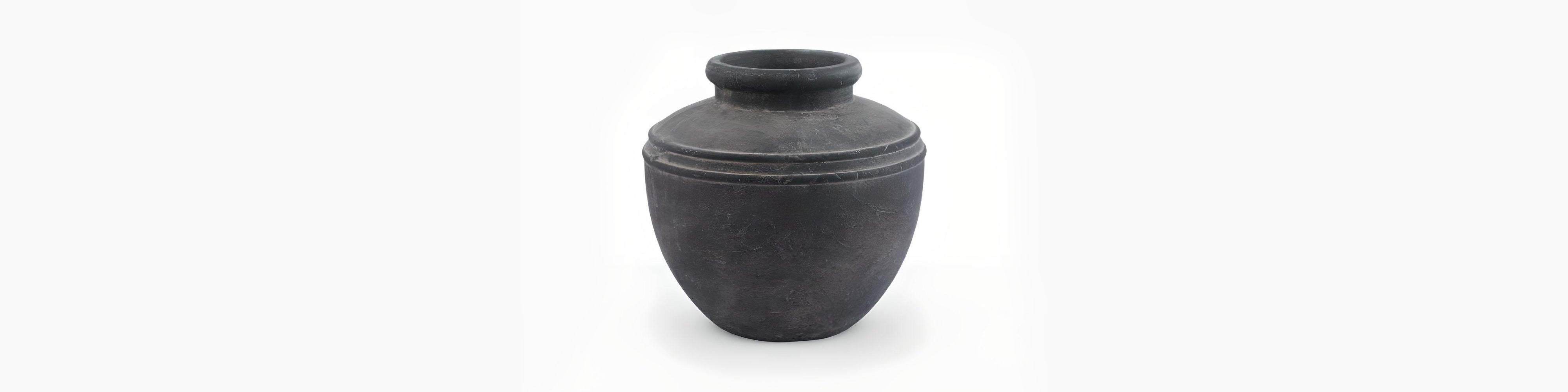 Signature Curated Ashbury Series Room Kit banner showcasing a charcoal-hued aged stone planter styled in a minimalist brutalist-Scandi living space by Christie’s Interior
