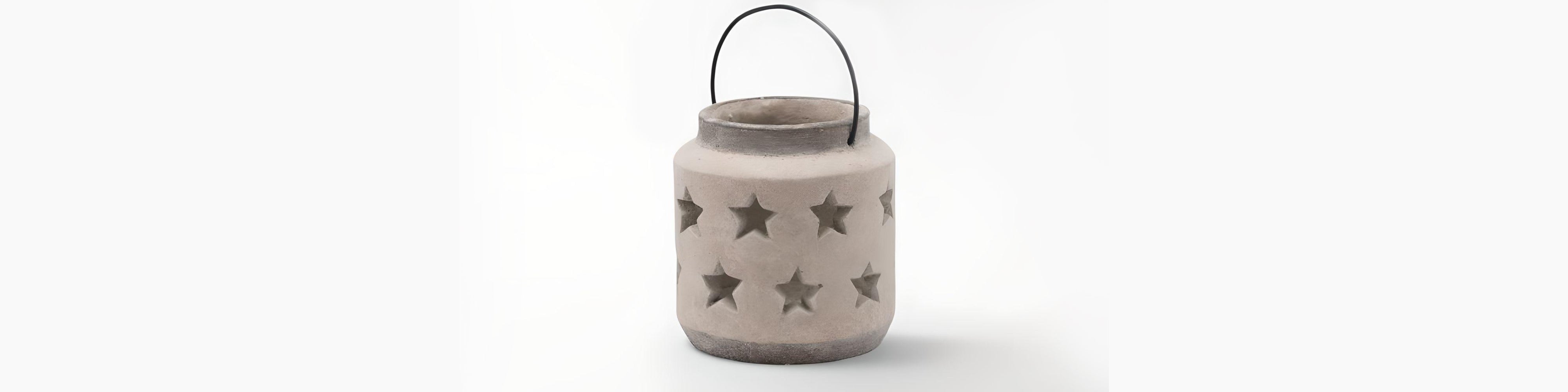 Signature Curated Faux-Floral Room Kit banner showcasing a stone star-cutout lantern with metal handle by Christie’s Interior
