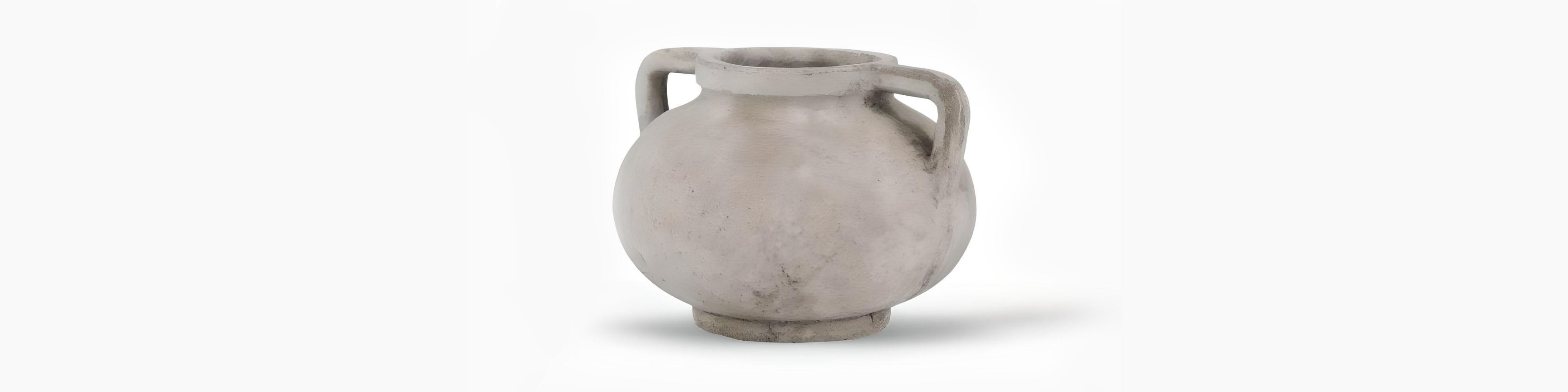 Signature Curated Halden Series Room Kit banner featuring a minimalist aged grey cement stone planter with sculptural handles in a brutalist-Scandi setting by Christie’s Interior
