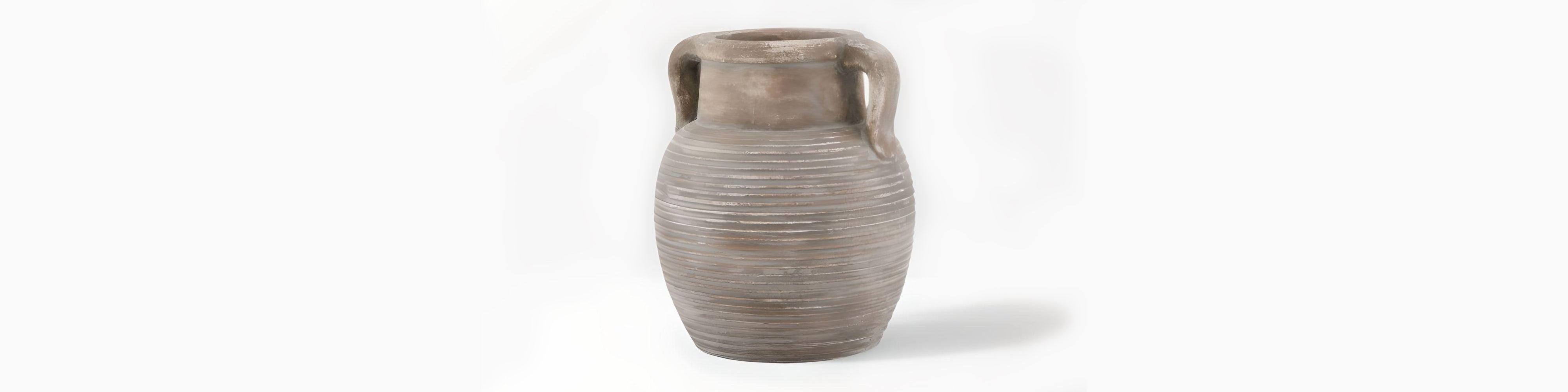 Signature Curated Lowther Series Room Kit banner showcasing a ribbed brown terracotta amphora vase with twin handles in a minimalist brutalist-Scandi interior by Christie’s Interior
