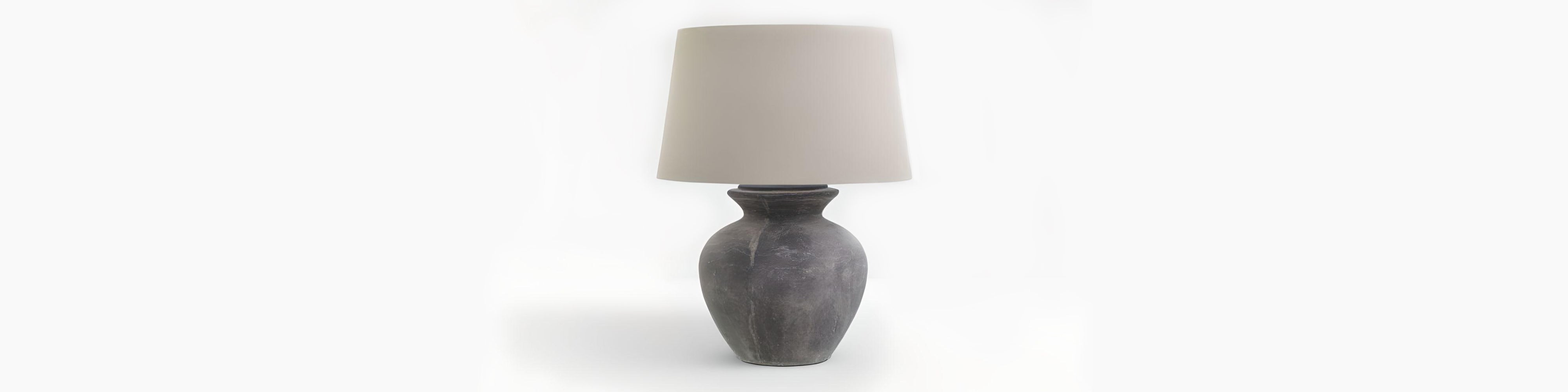 Signature Curated Table Lamp Room Kit banner showcasing a charcoal stoneware table lamp with linen drum shade styled in a minimalist brutalist-Scandi interior by Christie’s Interior
