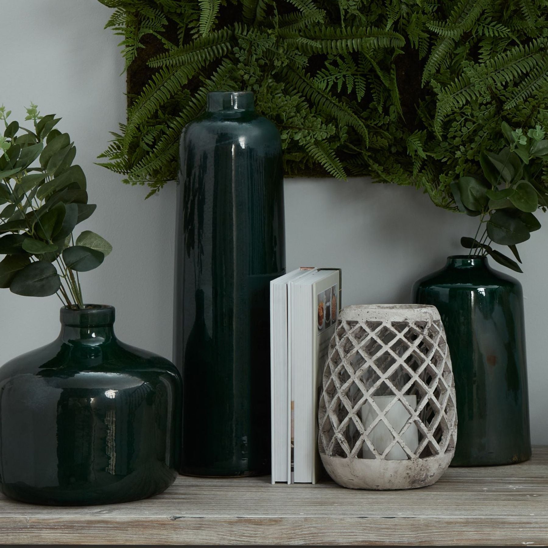 Whitford Emerald Ceramic Vase styled on a console with natural light, showing tonal glaze variation and sculptural profile
